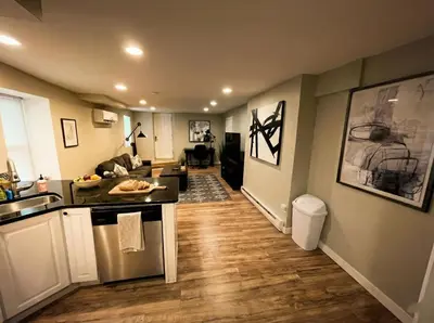 a kitchen and living room with a sink and a stove at Boardwalk- large modern unit with King bed fast WIFI free coffee and easy parking in Wilmington