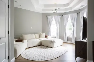 a white living room with a couch and a rug at Pike Creek Palace 6 Bedrooms with 5 King beds Villa in Wilmington's Chateau Country in Wilmington