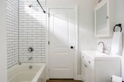 a white bathroom with a tub and a sink at Pike Creek Palace 6 Bedrooms with 5 King beds Villa in Wilmington's Chateau Country in Wilmington