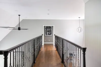 a hallway with a staircase with white walls and a white wall at Pike Creek Palace 6 Bedrooms with 5 King beds Villa in Wilmington's Chateau Country in Wilmington