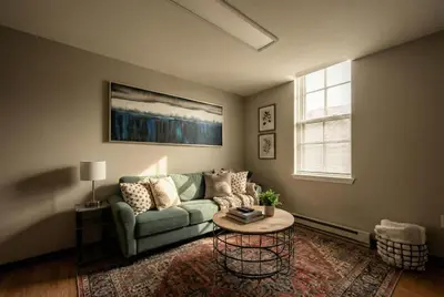 a living room with a couch and a table at The Terrace at Park Place 2nd floor walk up -cozy 2 bedroom fast WiFi free coffee in Wilmington