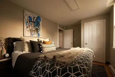 a bedroom with a large bed with pillows on it at The Terrace at Park Place 2nd floor walk up -cozy 2 bedroom fast WiFi free coffee in Wilmington