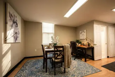 a dining room with a table and a desk at The Terrace at Park Place 2nd floor walk up -cozy 2 bedroom fast WiFi free coffee in Wilmington