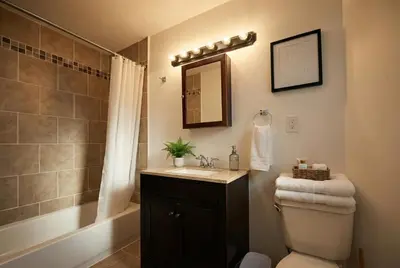 a bathroom with a sink and a toilet and a mirror at The Terrace at Park Place 2nd floor walk up -cozy 2 bedroom fast WiFi free coffee in Wilmington
