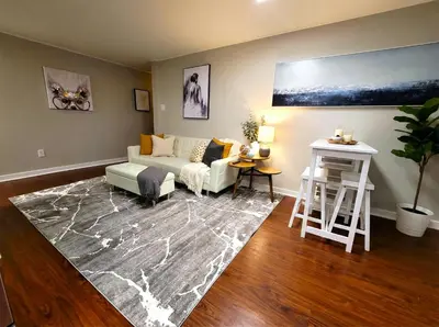 a living room with a couch and a rug at Redwood loft at Park Place King bed walk in closet fast WIFI and free coffee in Wilmington