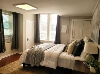 a bedroom with a large bed and a window at Redwood loft at Park Place King bed walk in closet fast WIFI and free coffee in Wilmington
