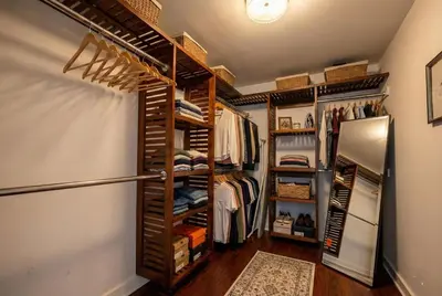 a walk in closet with wooden shelves at Redwood loft at Park Place King bed walk in closet fast WIFI and free coffee in Wilmington