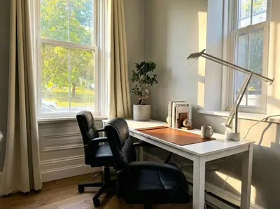 an office with a desk and two chairs in front of a window at The Grayson at Park Place- cozy and fully updated with King bed free coffee and fast WIFI in Wilmington