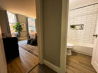 a bathroom with a toilet and a bath tub at The Grayson at Park Place- cozy and fully updated with King bed free coffee and fast WIFI in Wilmington