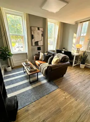 a living room with a couch and a table at The Grayson at Park Place- cozy and fully updated with King bed free coffee and fast WIFI in Wilmington