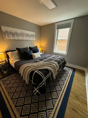 a bedroom with a large bed and a window at Cozy unit King bed & laundry in Wilmington