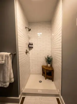 a bathroom with a shower with white tiles at Cozy unit King bed & laundry in Wilmington