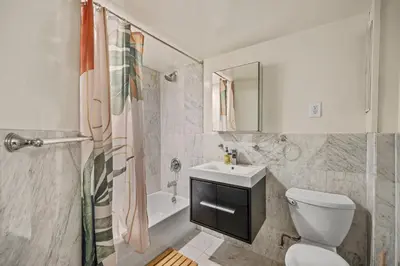 a bathroom with a toilet and a sink and a shower at Oasis Apartment in the Heart of Union Square Downtown Manhattan in New York