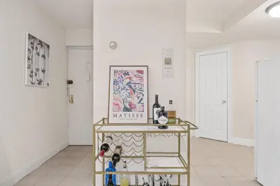 a room with a table with wine bottles on it at Oasis Apartment in the Heart of Union Square Downtown Manhattan in New York