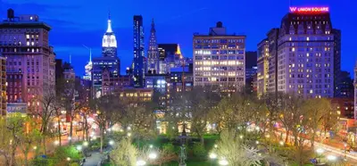 a view of a city at night with lights at Heart of Downtown Manhattan - Stylish One Bedroom Apartment in Vibrant Union Square in New York