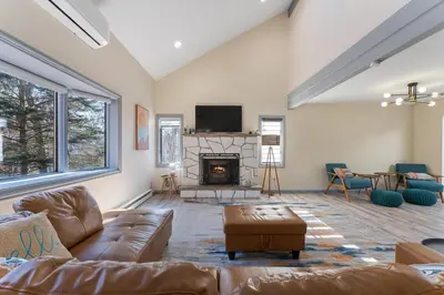 a living room with a couch and a fireplace at Gorgeous 5BD w Hot-Tub & Pool villa located in the middle of Pocono in East Stroudsburg