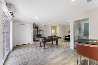 a living room with a pool table in it at Gorgeous 5BD w Hot-Tub & Pool villa located in the middle of Pocono in East Stroudsburg