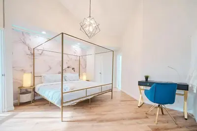 a bedroom with a canopy bed and a desk at Wonderful Family Place w/HotTub/Sauna/Billiard/Private Pool in East Stroudsburg