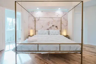 a bedroom with a metal bed with a marble wall at Wonderful Family Place w/HotTub/Sauna/Billiard/Private Pool in East Stroudsburg