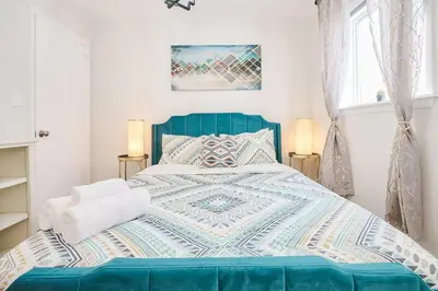 a bedroom with a blue bed with a quilt on it at Wonderful Family Place w/HotTub/Sauna/Billiard/Private Pool in East Stroudsburg