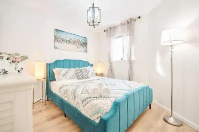 a blue bed in a white room with a window at Wonderful Family Place w/HotTub/Sauna/Billiard/Private Pool in East Stroudsburg