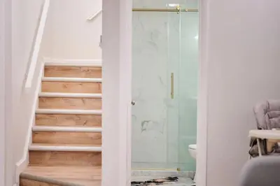a bathroom with a walk in shower next to a staircase at Wonderful Family Place w/HotTub/Sauna/Billiard/Private Pool in East Stroudsburg