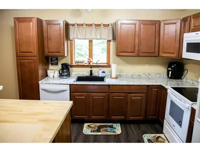 a kitchen with wooden cabinets and a sink at Cozy Palace in Livingston Manor