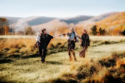 three women walking in a field with a child at 37 Oak Ridge House in Wellsboro