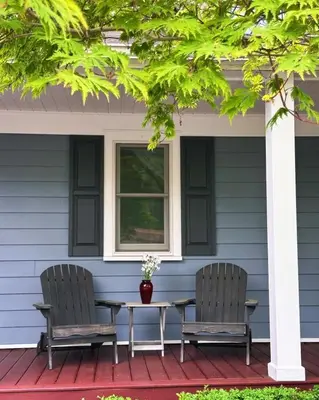 two chairs and a table on the porch of a house at 37 Oak Ridge House in Wellsboro