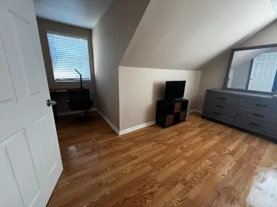 an empty living room with a television and a dresser at Spacious 3 BR Ewing Home -Quiet in Trenton