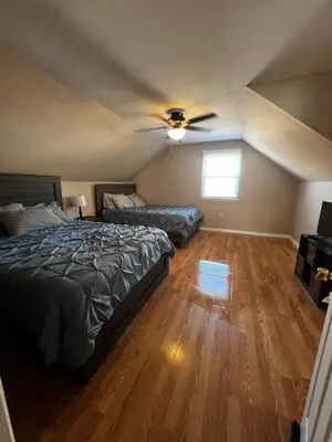 a bedroom with two beds and a ceiling fan at Spacious 3 BR Ewing Home -Quiet in Trenton