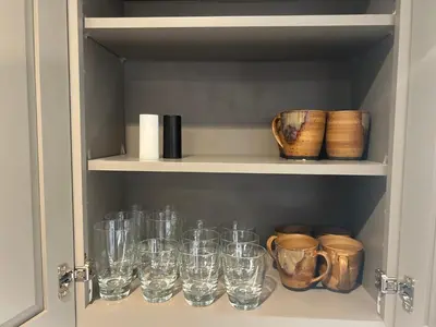 a cupboard filled with glasses and other glass items at Spacious 3 BR Ewing Home -Quiet in Trenton