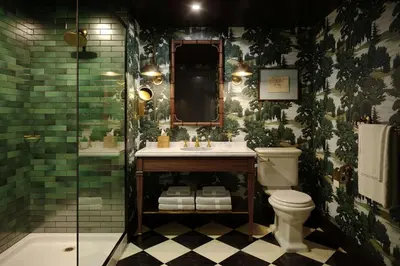 a bathroom with a toilet and a shower with green tiles at Graduate by Hilton Princeton in Princeton