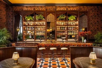 a bar with a checkered floor and stools at Graduate by Hilton Princeton in Princeton