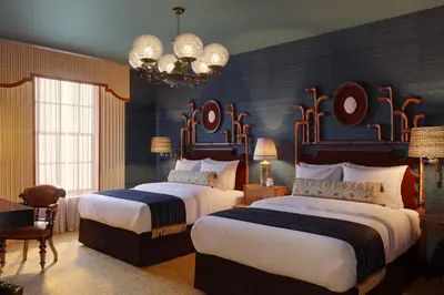 a hotel room with two beds and a chandelier at Graduate by Hilton Princeton in Princeton
