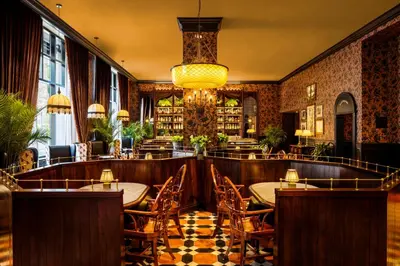 a restaurant with tables and chairs in a room at Graduate by Hilton Princeton in Princeton