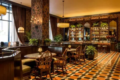 a restaurant with tables and chairs and a bar at Graduate by Hilton Princeton in Princeton