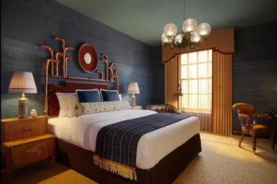 a bedroom with a large bed with a blue wall at Graduate by Hilton Princeton in Princeton
