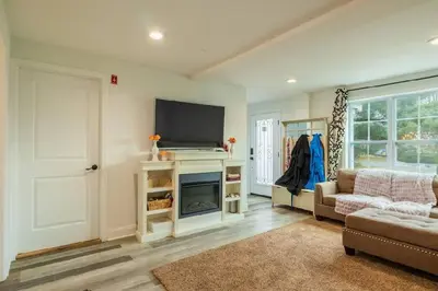 a living room with a flat screen tv and a couch at A home away from home in Hightstown