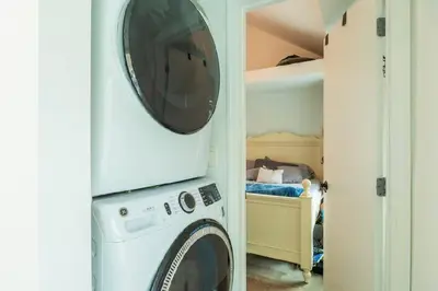 a washer and dryer in a room with a bedroom at A home away from home in Hightstown