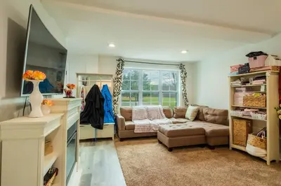 a living room with a couch and a table at A home away from home in Hightstown