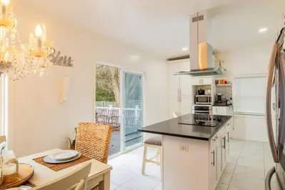 a kitchen with white walls and a black counter top at A home away from home in Hightstown