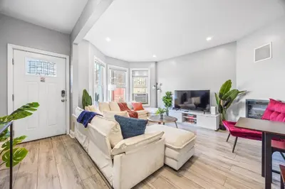 a living room with a couch and a tv at Newark's Family Favorite Place in Newark