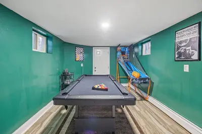 a green room with a table and a slide at Newark's Family Favorite Place in Newark
