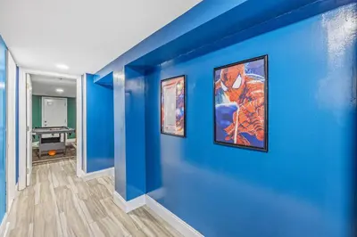 a blue wall with three paintings on it at Newark's Family Favorite Place in Newark