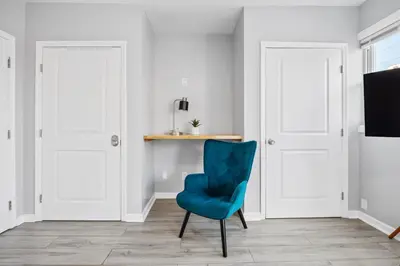 a blue chair in a room with white doors at Newark's Family Favorite Place in Newark
