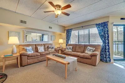 a living room with two couches and a ceiling fan at Lake Harmony Condo with Big Boulder Lake Views in Lake Harmony