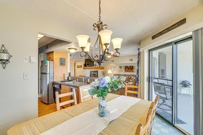 a dining room table with a vase of flowers on it at Lake Harmony Condo with Big Boulder Lake Views in Lake Harmony