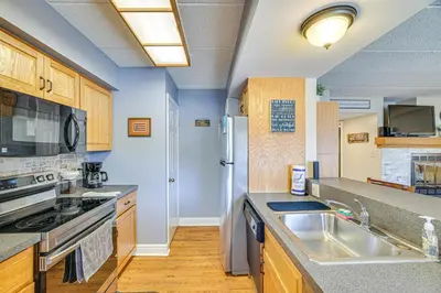 a kitchen with a sink and a refrigerator at Lake Harmony Condo with Big Boulder Lake Views in Lake Harmony