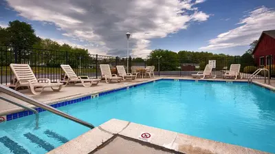 a large swimming pool with chairs and a table at Best Western Carlisle in Carlisle